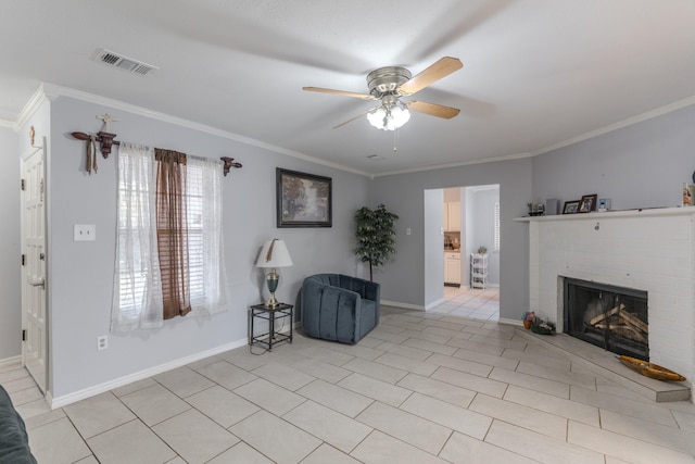 living area with ceiling fan, light tile patterned flooring, ornamental molding, and a fireplace