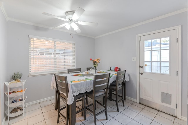 dining space with light tile patterned floors, a wealth of natural light, crown molding, and ceiling fan