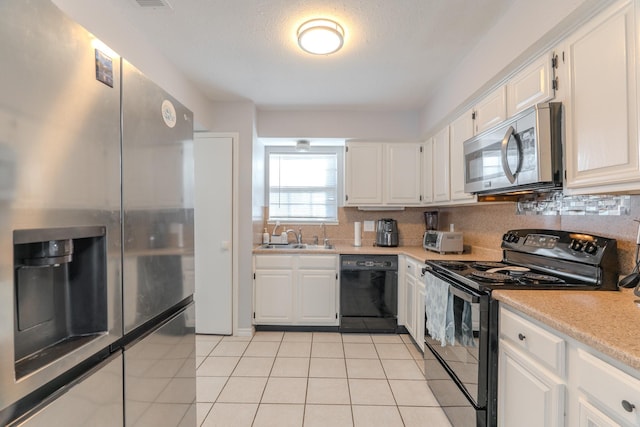 kitchen with backsplash, white cabinetry, sink, and black appliances