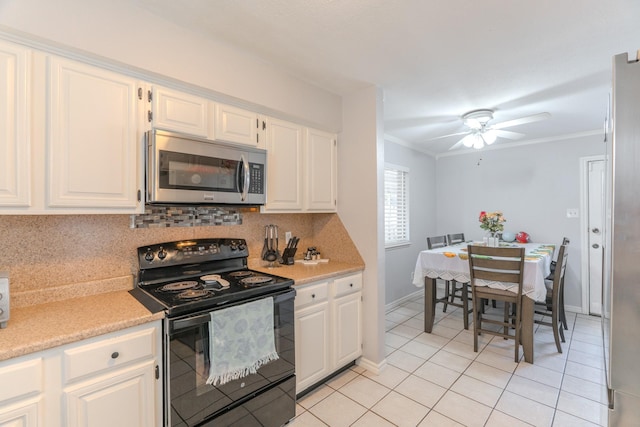 kitchen with black range with electric stovetop, white cabinetry, ceiling fan, crown molding, and decorative backsplash