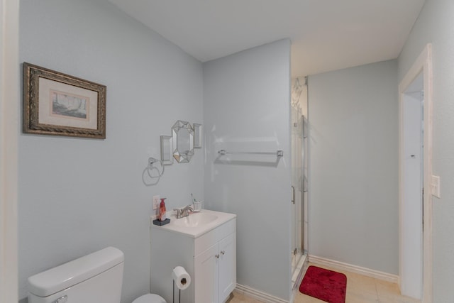 bathroom with tile patterned flooring, vanity, an enclosed shower, and toilet