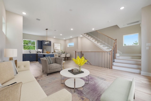 living room featuring light hardwood / wood-style floors and sink