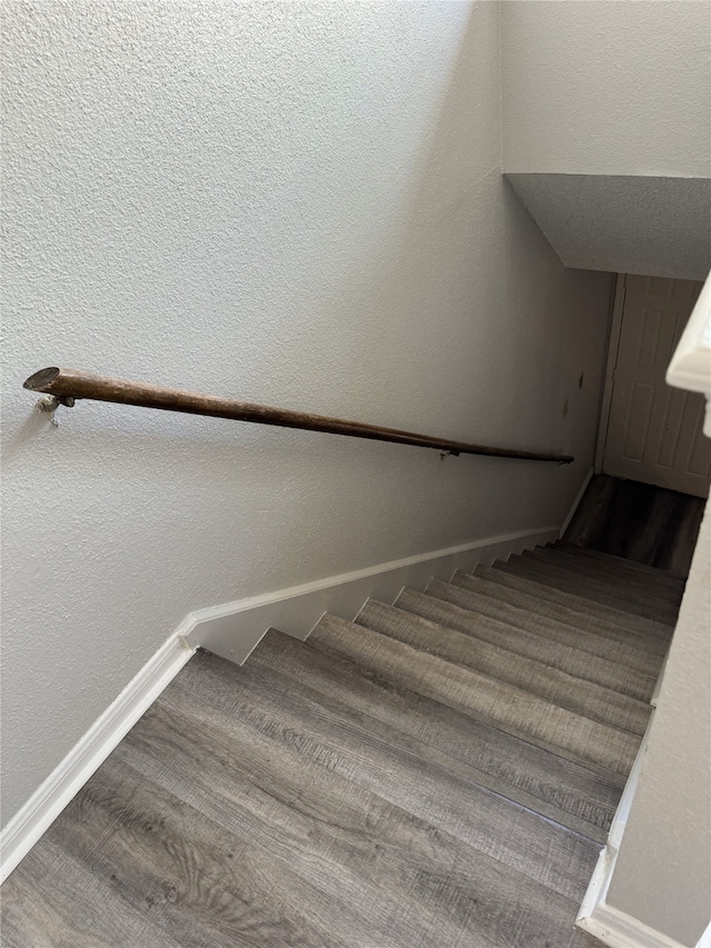 staircase featuring hardwood / wood-style flooring