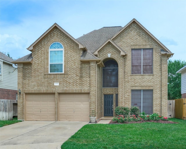 view of front of house with a front yard and a garage