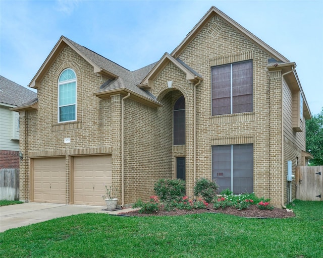 view of property featuring a front yard and a garage