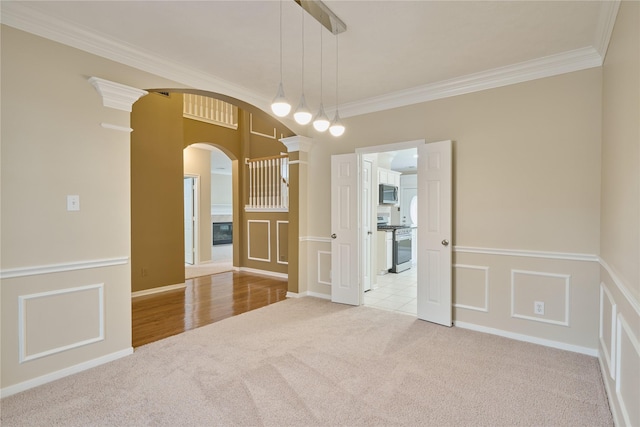 unfurnished room featuring light colored carpet and crown molding