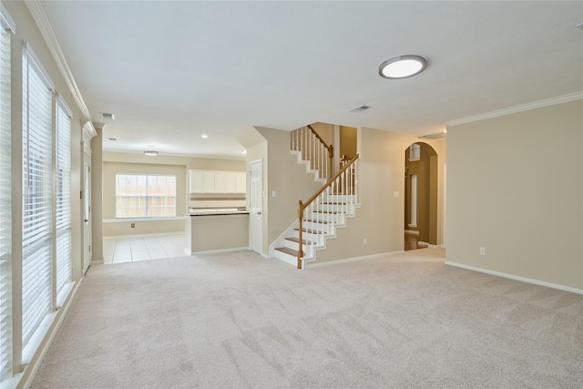 unfurnished living room with light carpet and ornamental molding