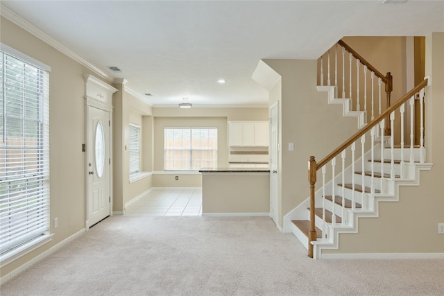 entryway featuring light colored carpet and ornamental molding