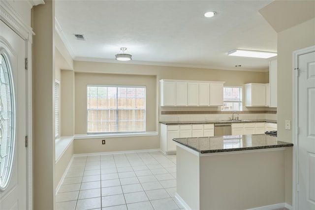 kitchen featuring dishwasher, backsplash, white cabinets, ornamental molding, and kitchen peninsula