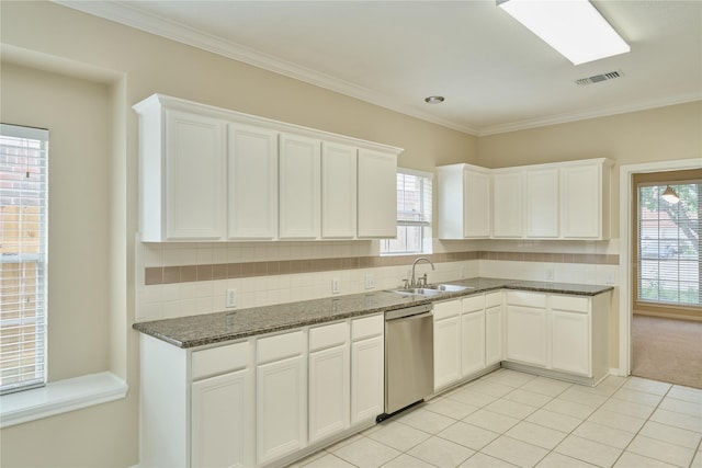 kitchen featuring white cabinetry, dishwasher, and plenty of natural light