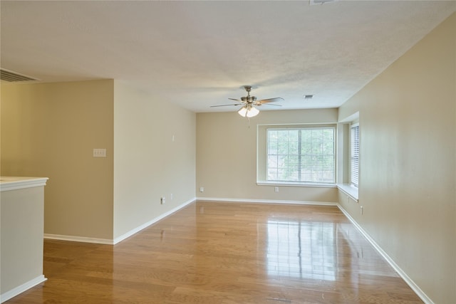 unfurnished room featuring light hardwood / wood-style floors and ceiling fan