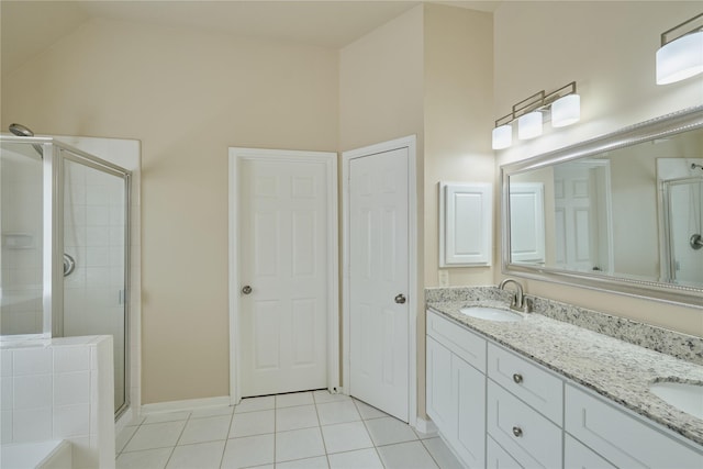 bathroom with tile patterned flooring, vanity, a shower with door, and high vaulted ceiling