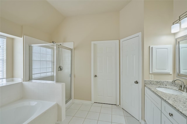 bathroom with tile patterned floors, vanity, separate shower and tub, and lofted ceiling