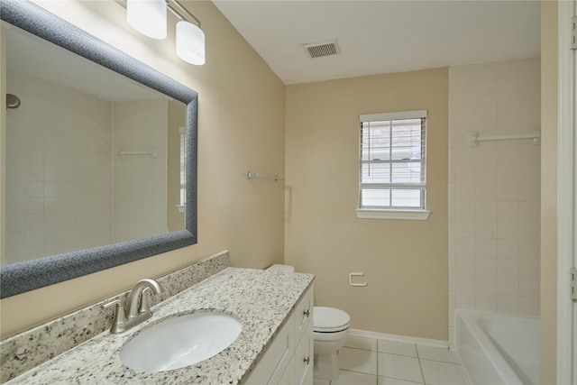 full bathroom featuring toilet, vanity, tile patterned floors, and tiled shower / bath combo