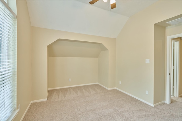 bonus room with ceiling fan, light carpet, and vaulted ceiling