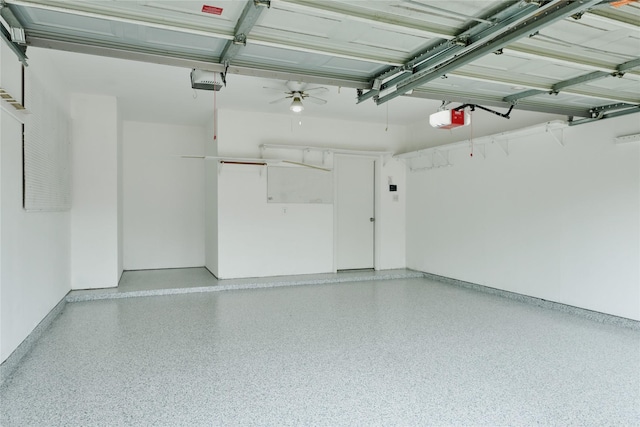 garage with a garage door opener and ceiling fan