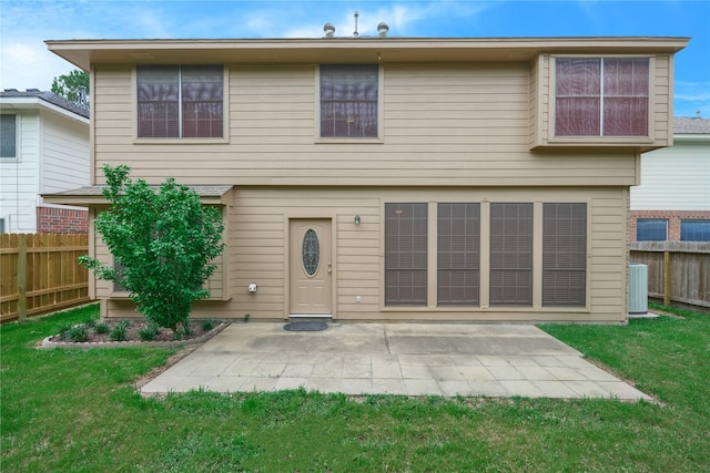 back of house with a lawn, a patio area, and central AC unit