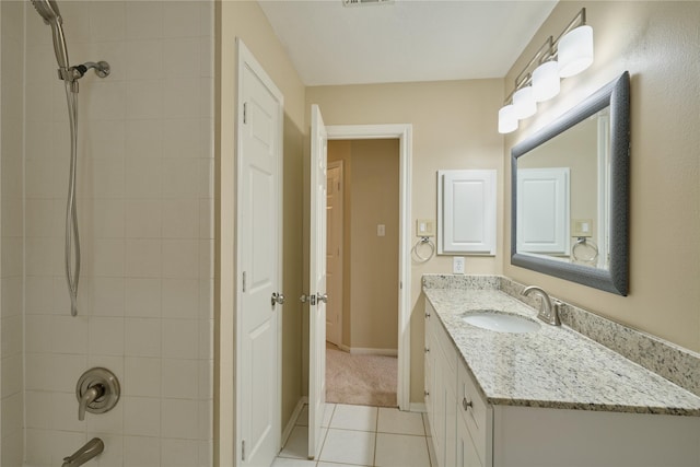 bathroom with tile patterned floors, tiled shower / bath combo, and vanity