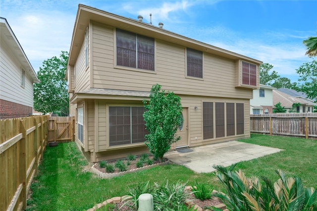 rear view of house featuring a patio area and a yard