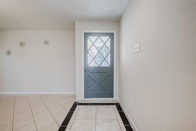 tiled foyer featuring a textured ceiling