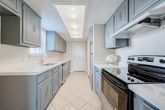 kitchen with stainless steel appliances, extractor fan, sink, light tile patterned floors, and gray cabinets