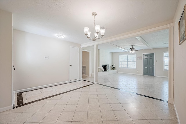 interior space featuring a textured ceiling and ceiling fan with notable chandelier