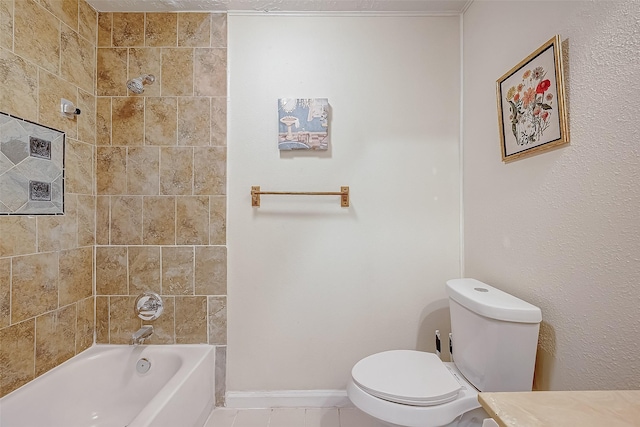 bathroom featuring tiled shower / bath combo and toilet