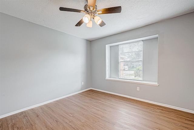 empty room featuring ceiling fan, a textured ceiling, and light hardwood / wood-style flooring