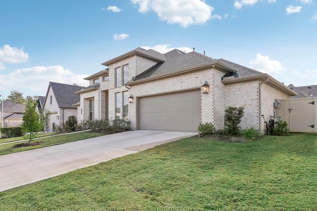 french country style house with a front yard and a garage