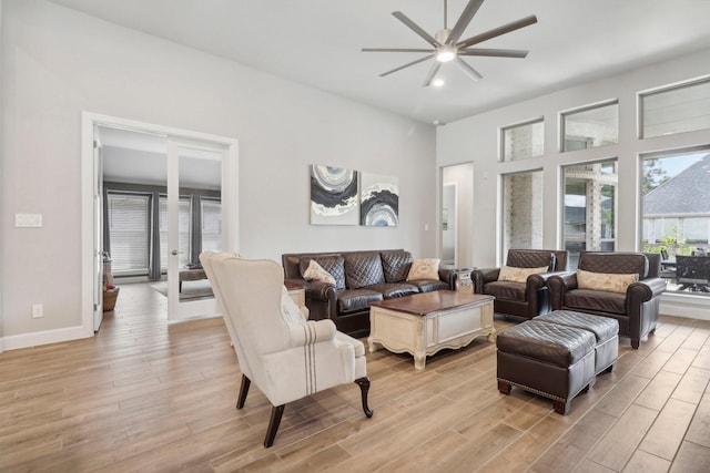 living room featuring ceiling fan and light wood-type flooring