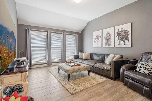 living room with light hardwood / wood-style flooring and lofted ceiling