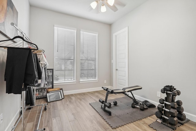 exercise room with ceiling fan and light hardwood / wood-style flooring