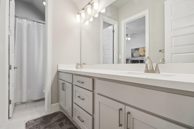 bathroom with tile patterned floors, vanity, and ceiling fan