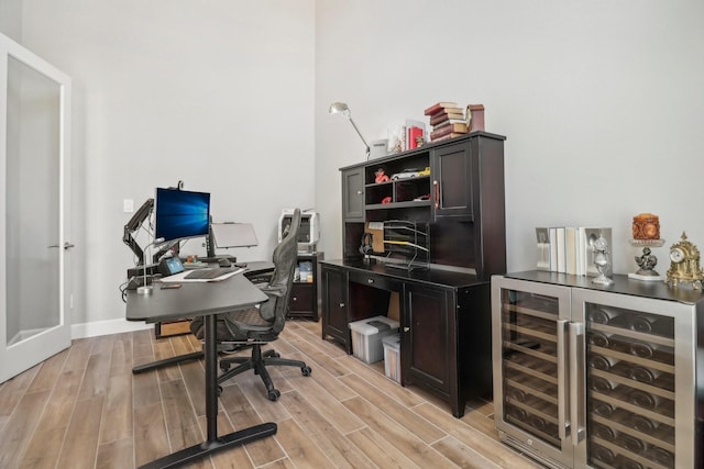 office area featuring light hardwood / wood-style floors and wine cooler