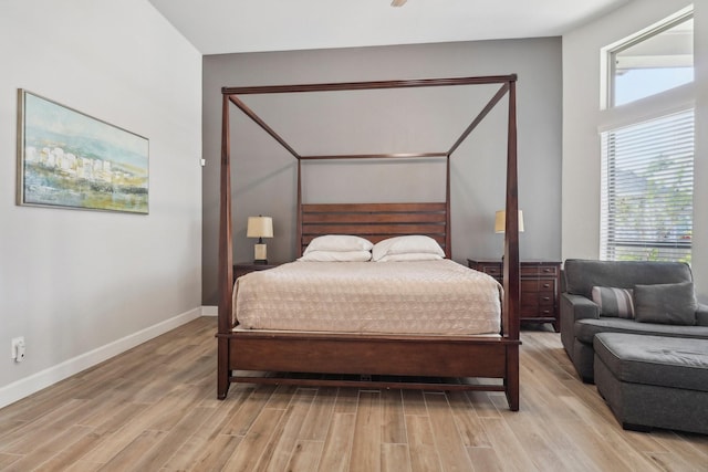 bedroom with light wood-type flooring and multiple windows