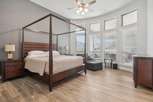 bedroom with ceiling fan and light hardwood / wood-style flooring