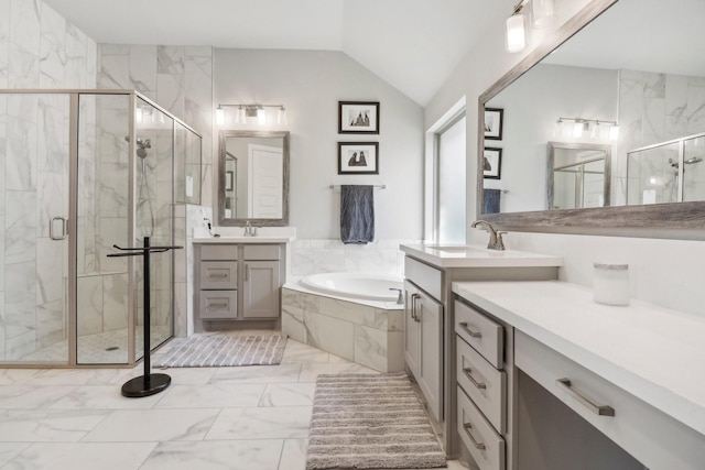 bathroom with vanity, lofted ceiling, and independent shower and bath