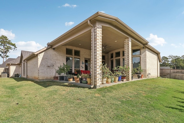 rear view of house featuring a lawn