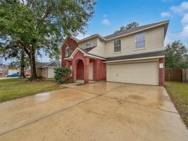 view of property with a front lawn and a garage