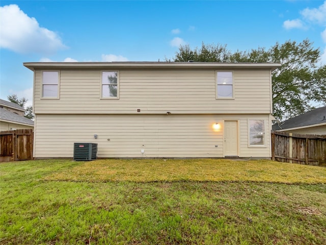 back of property featuring a yard and cooling unit