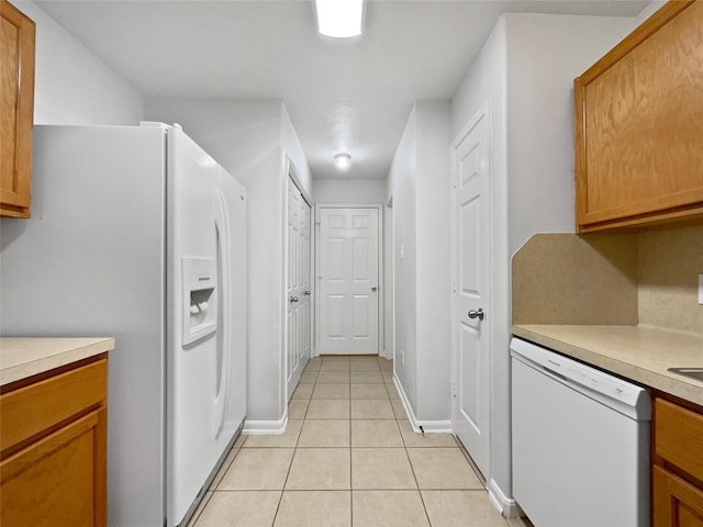 kitchen featuring white appliances and light tile patterned floors