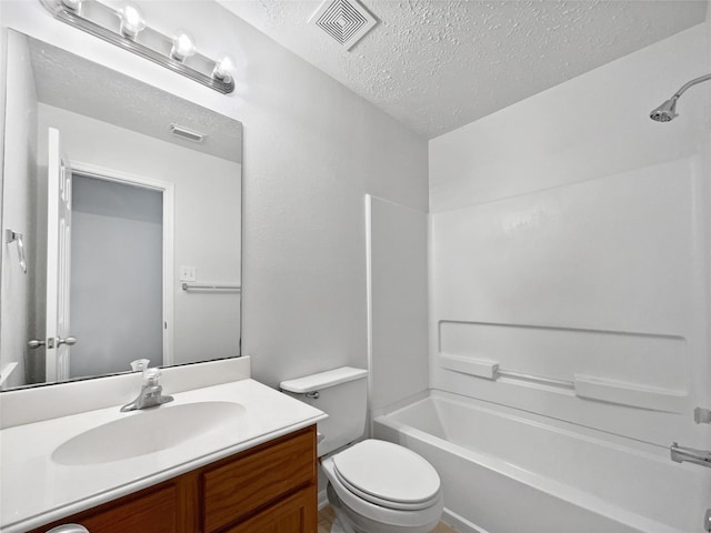 full bathroom with vanity, shower / bath combination, a textured ceiling, and toilet