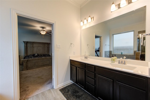 bathroom with vanity, ceiling fan, wood-type flooring, and crown molding