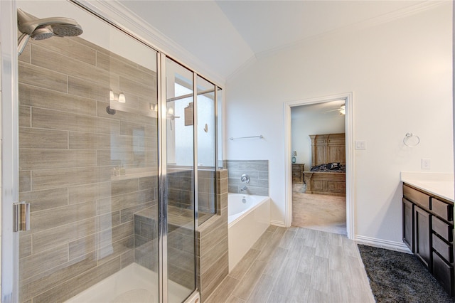 bathroom featuring plus walk in shower, vanity, lofted ceiling, and hardwood / wood-style flooring