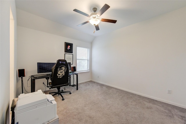 office space featuring light carpet, ceiling fan, and vaulted ceiling