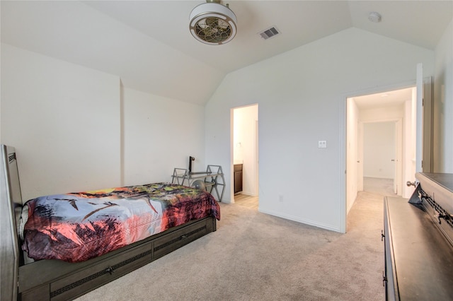 carpeted bedroom featuring connected bathroom and vaulted ceiling