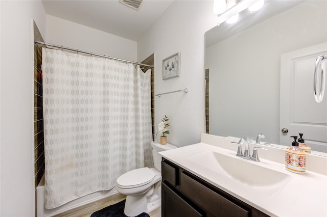 full bathroom featuring shower / tub combo, vanity, hardwood / wood-style flooring, and toilet