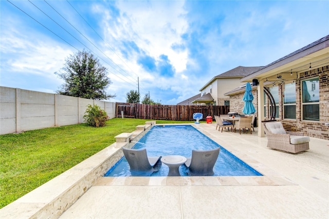 view of swimming pool featuring pool water feature, a patio area, and a lawn