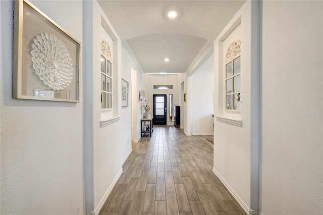 hallway with crown molding and dark hardwood / wood-style flooring