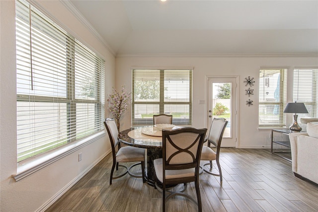 dining room featuring dark hardwood / wood-style flooring, vaulted ceiling, and ornamental molding